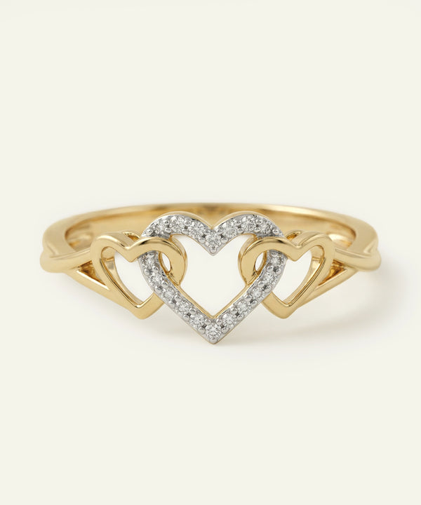Gold ring with interlocking heart designs on a white background