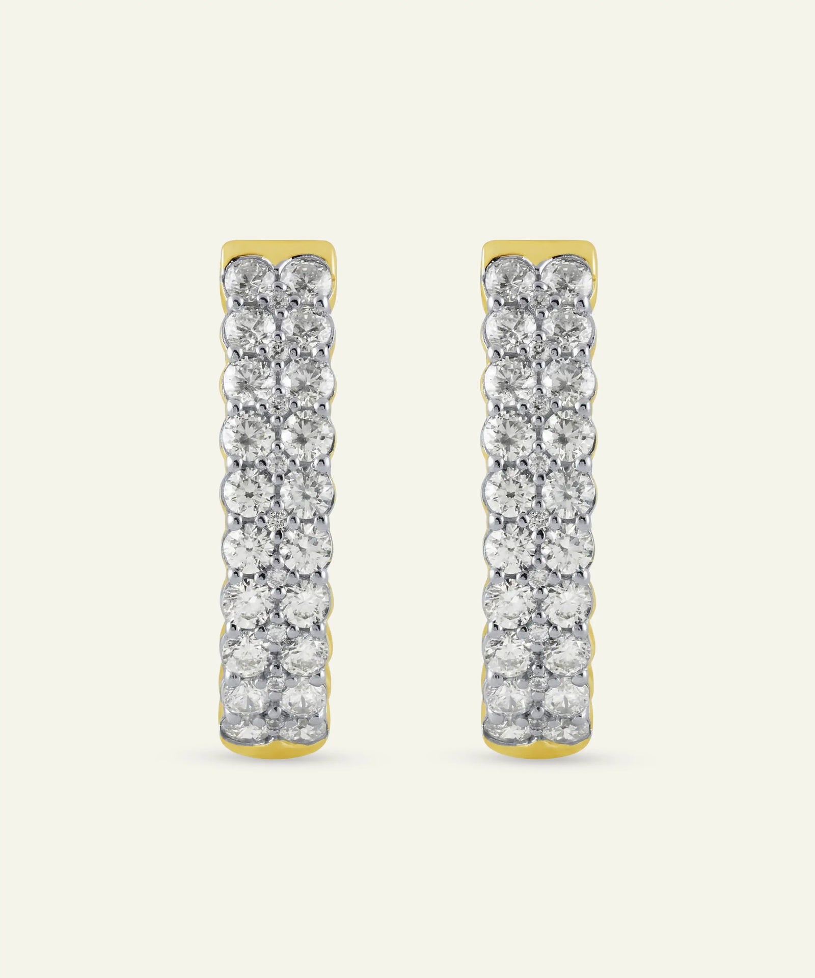 Pair of gold and diamond earrings on a white background