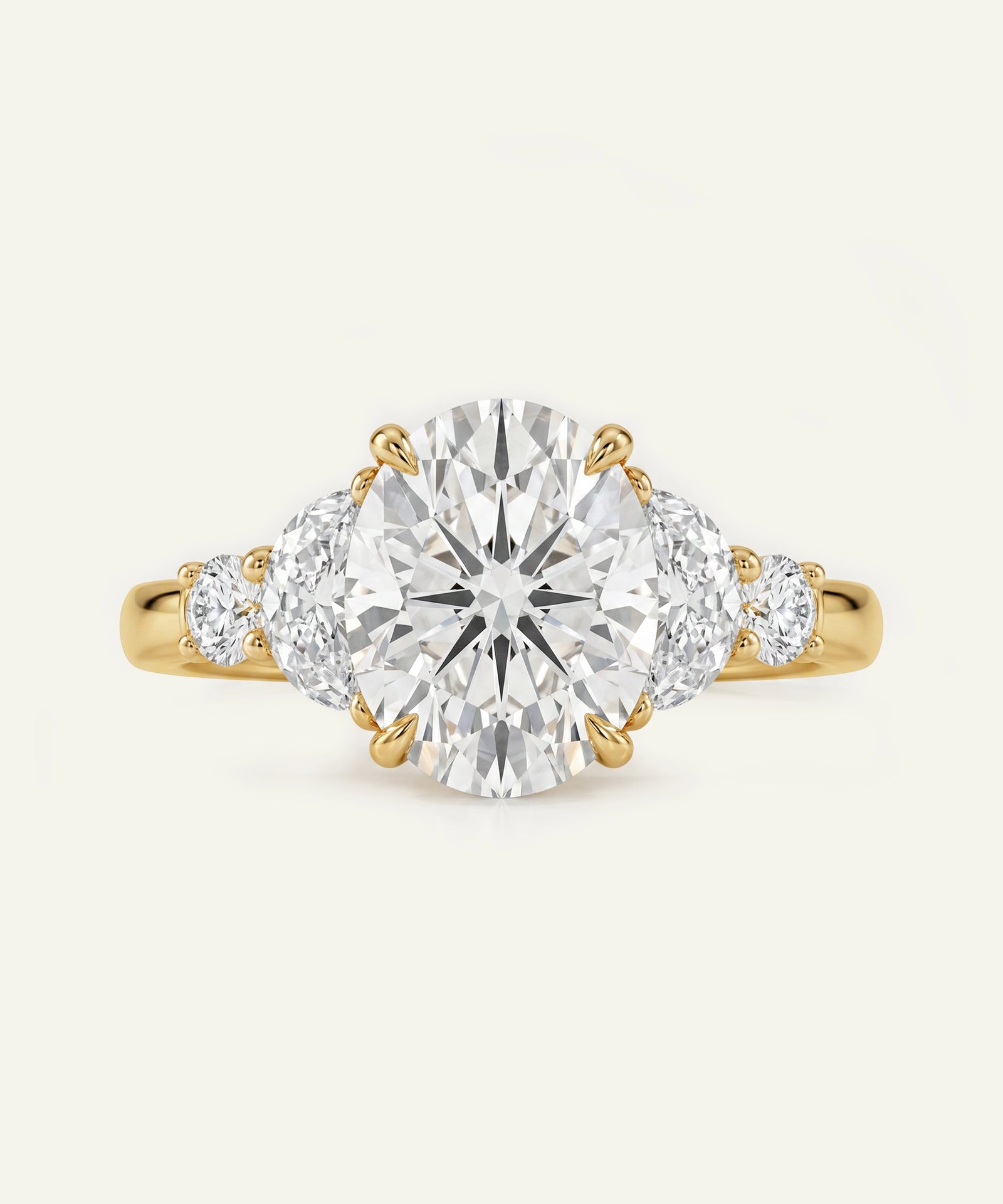 Gold ring with a large diamond and two smaller diamonds on a white background