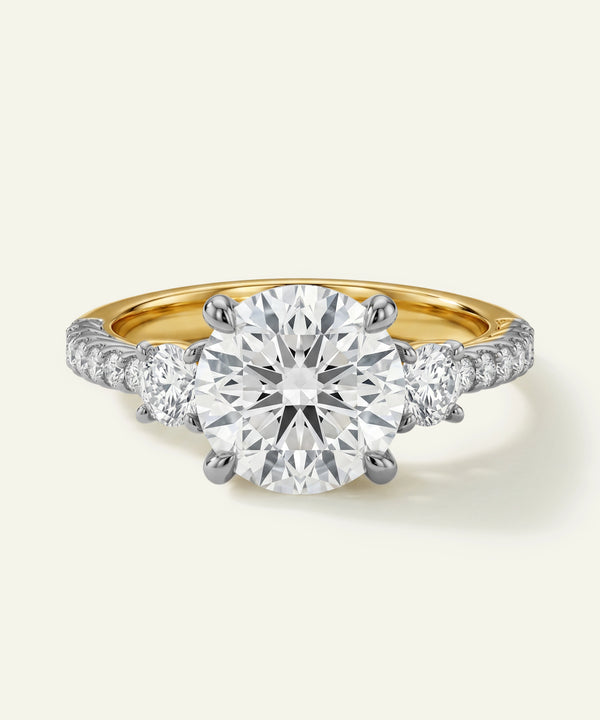 Gold and silver diamond ring on a light gray background