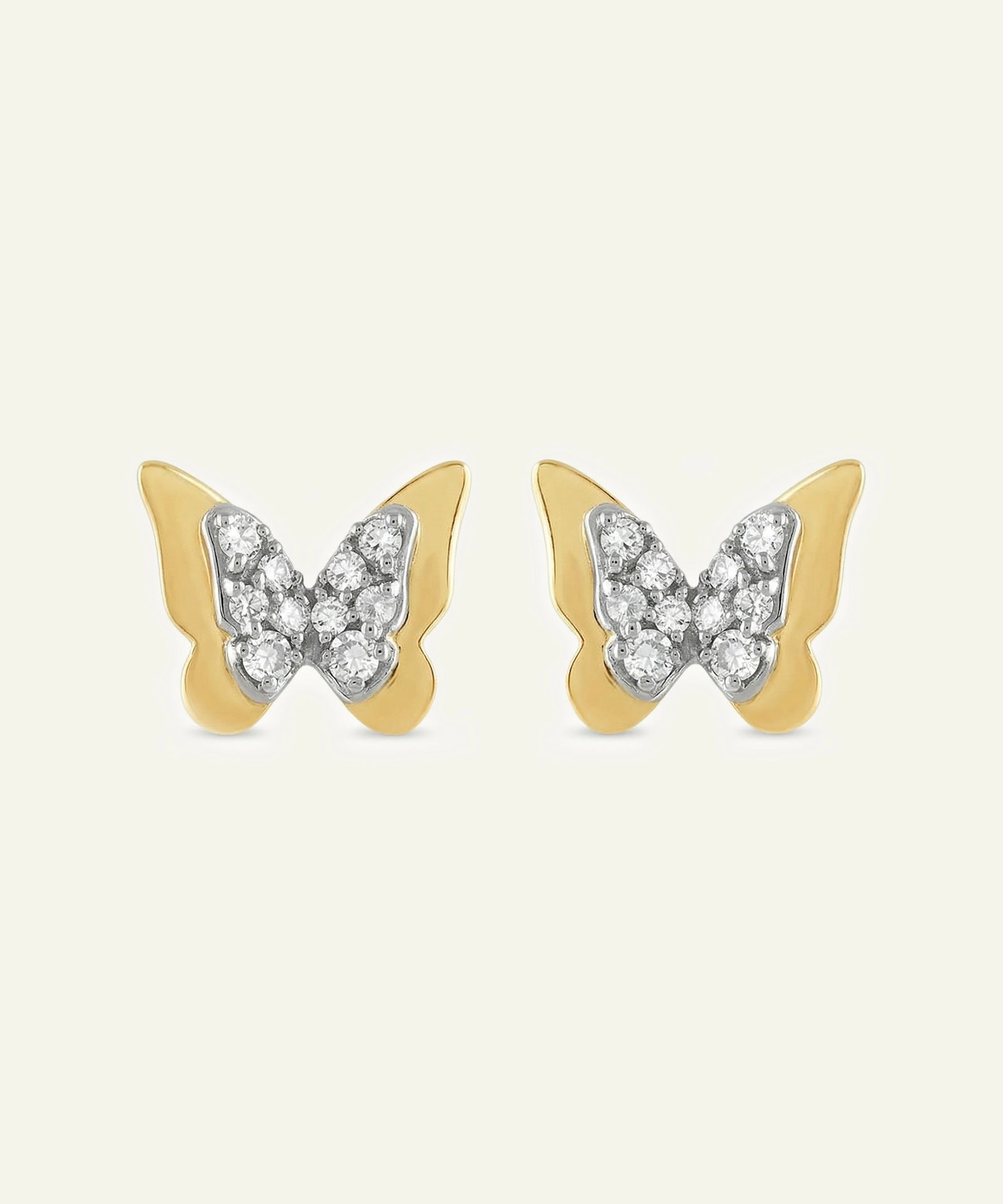 Butterfly-shaped earrings with gold and silver design on a white background
