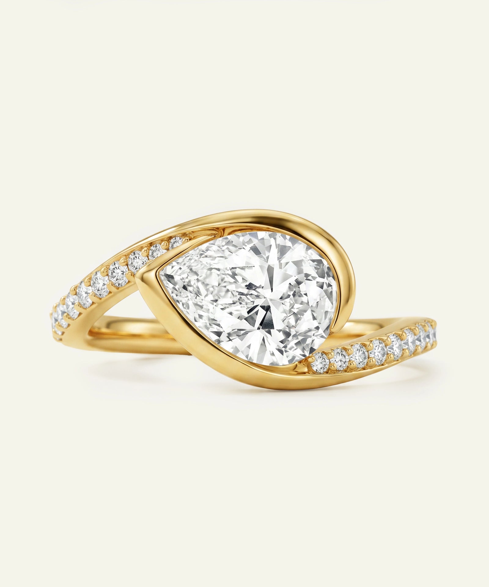 Gold ring with a large diamond and smaller diamonds on the band against a white background