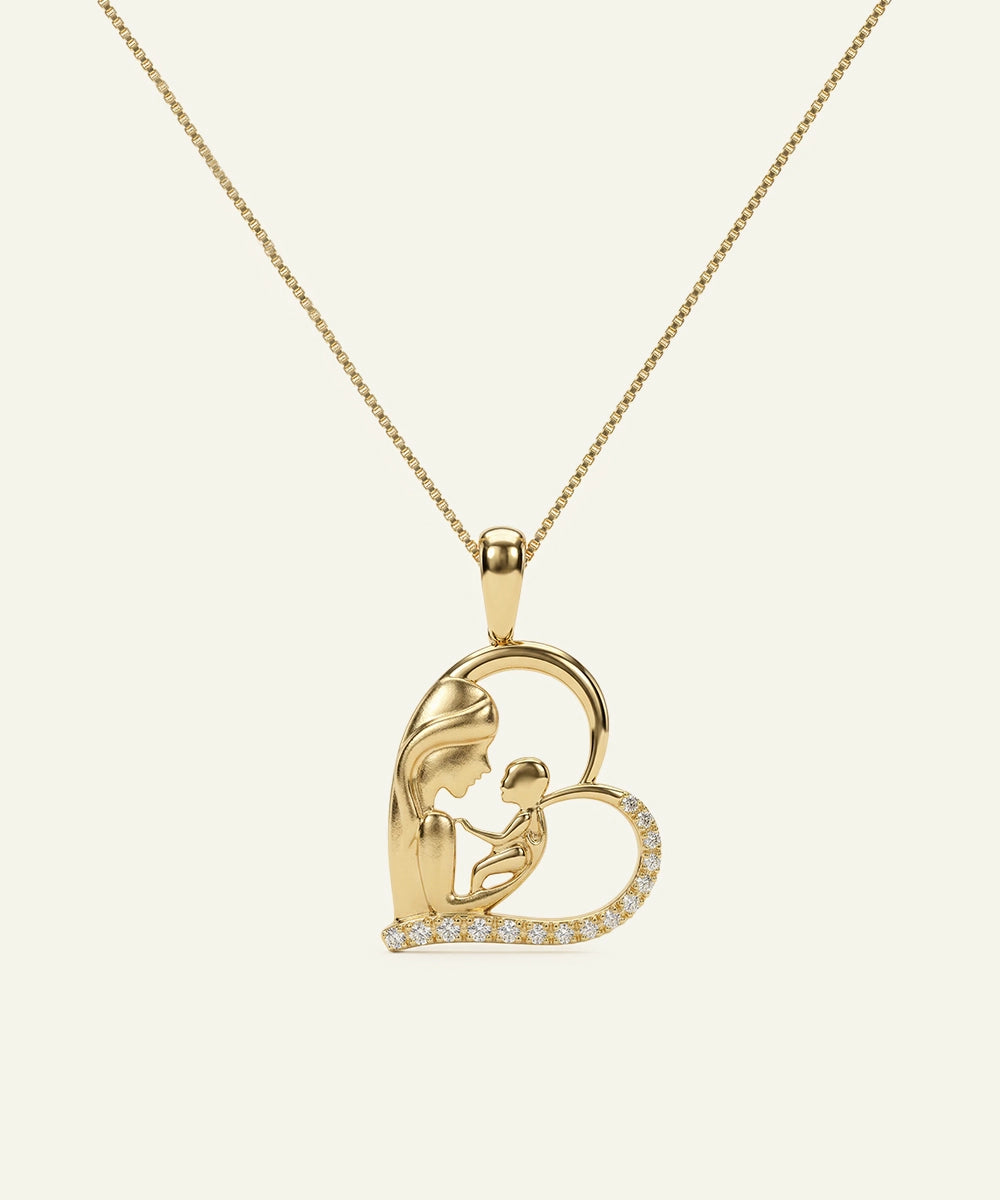 Gold pendant with a heart design on a beige background