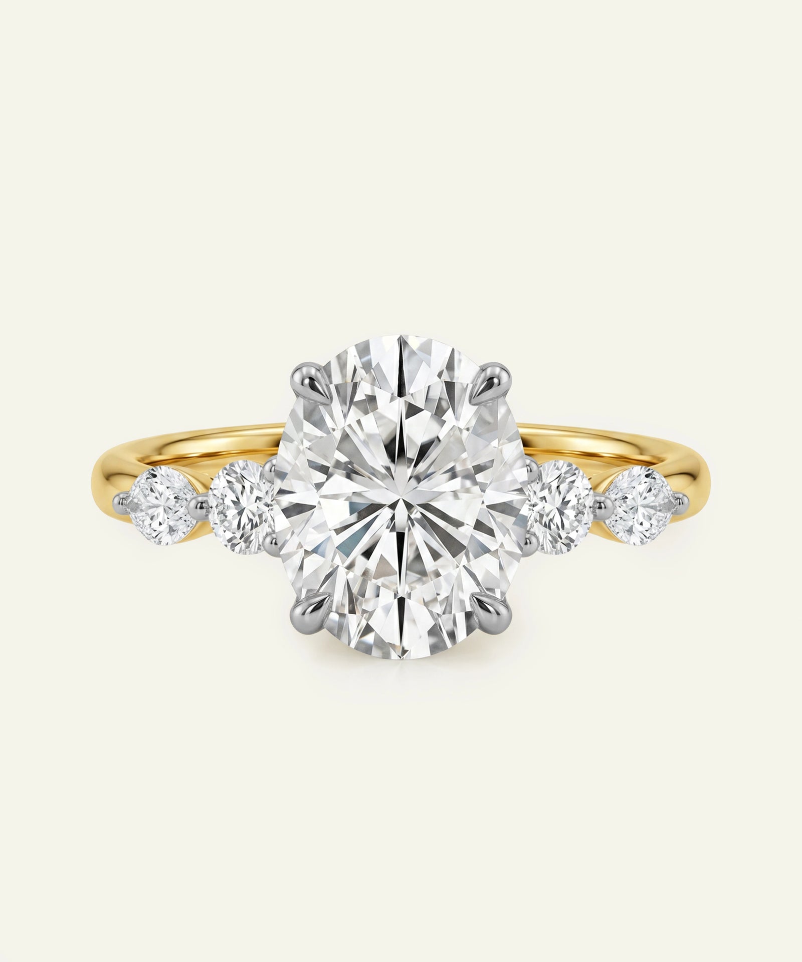 Diamond ring with a yellow gold band on a white background