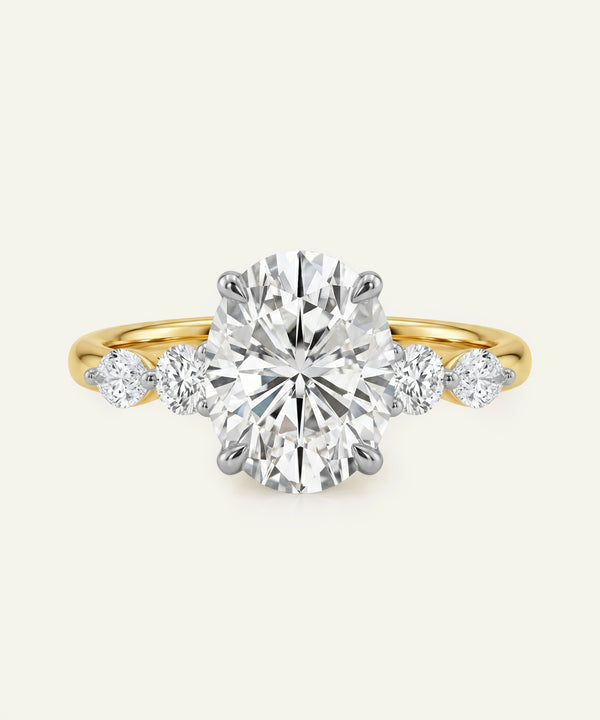 Diamond ring with a yellow gold band on a white background