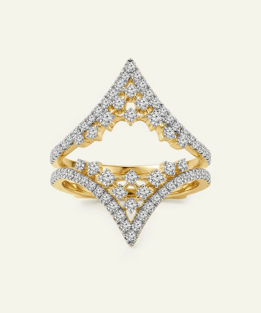 Gold and diamond ring with a geometric design on a light gray background