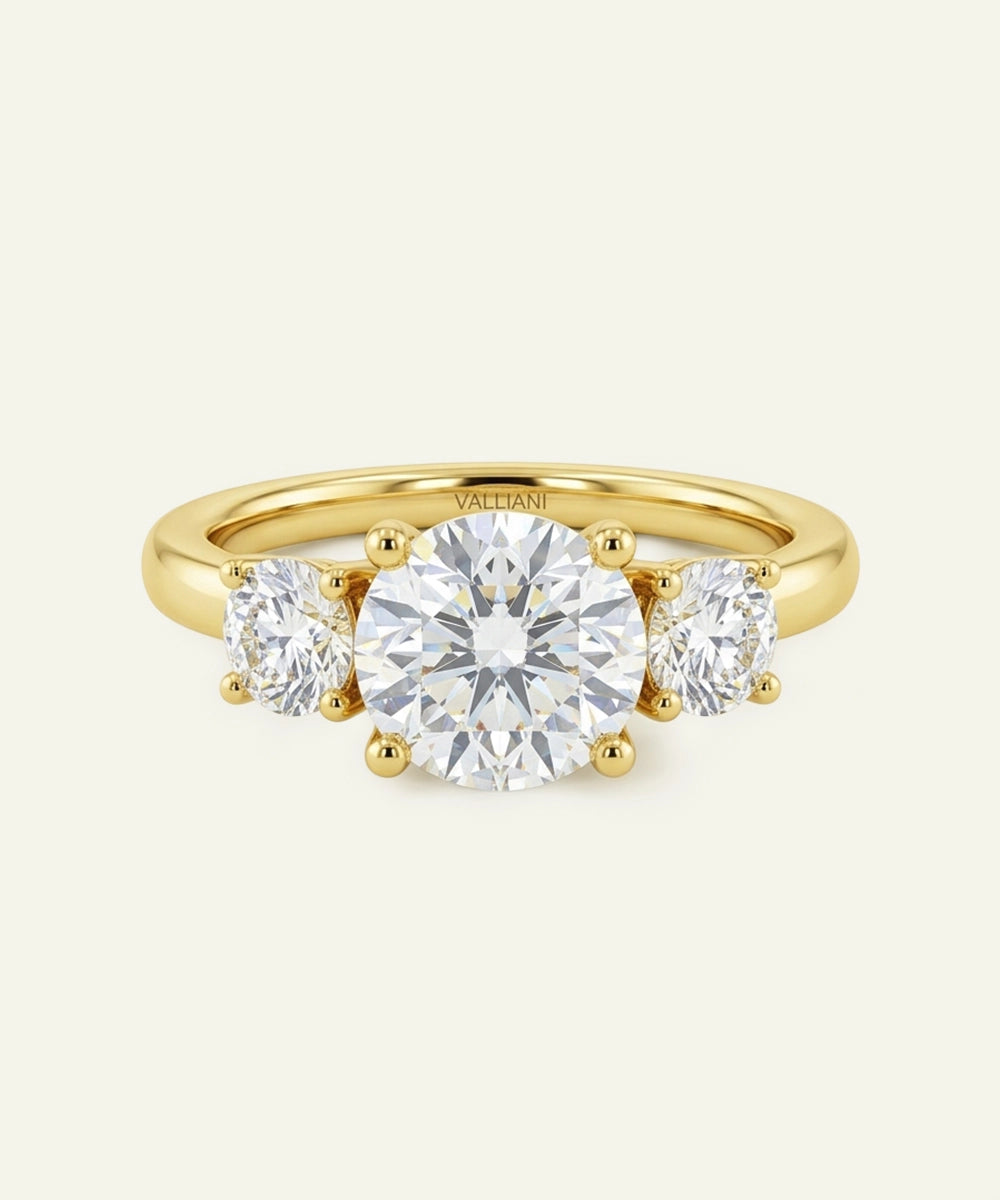 Gold ring with three diamonds on a white background