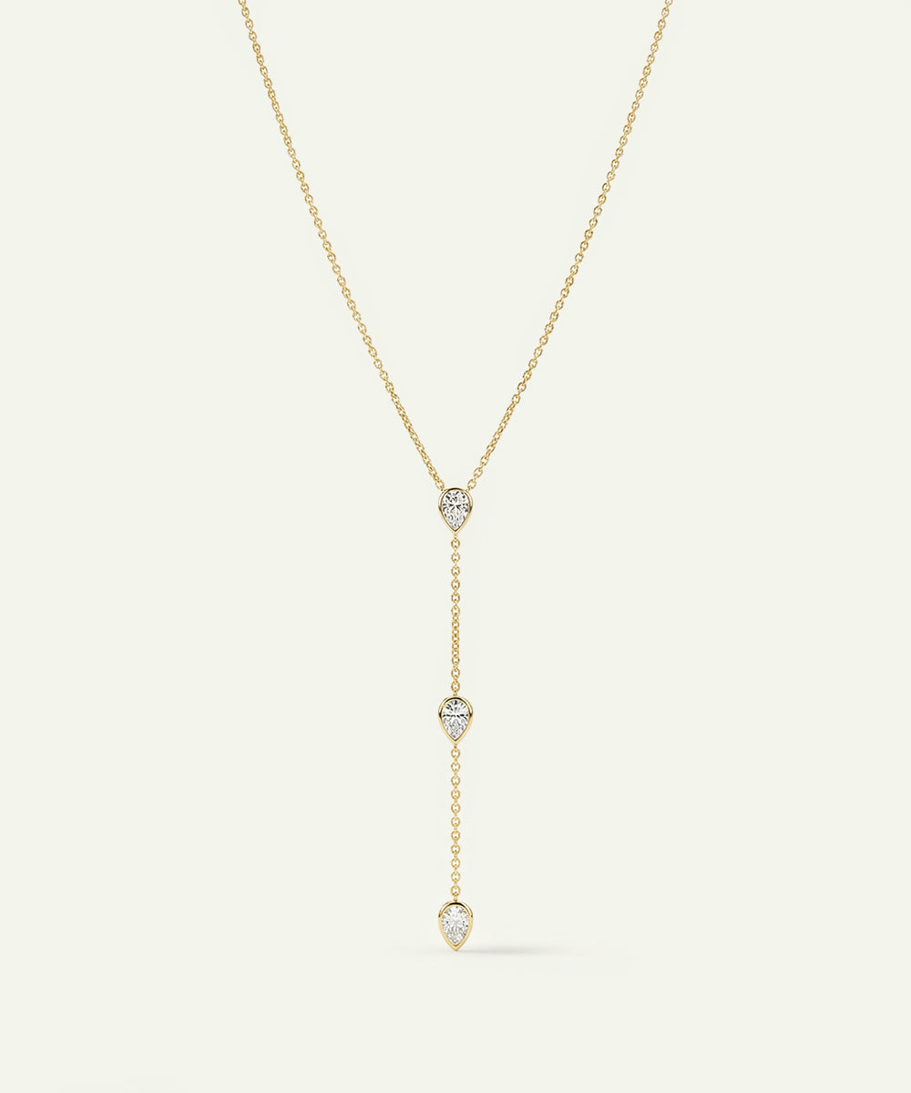 Gold necklace with diamond pendants on a white background