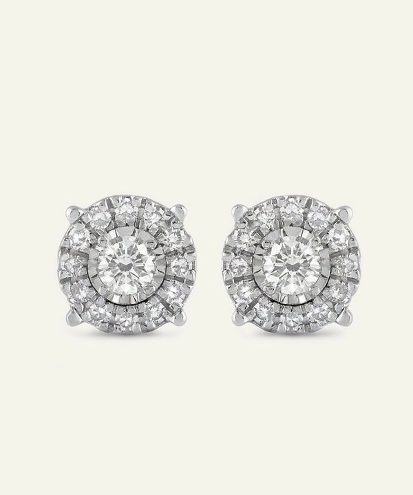 Pair of diamond stud earrings on a light gray background
