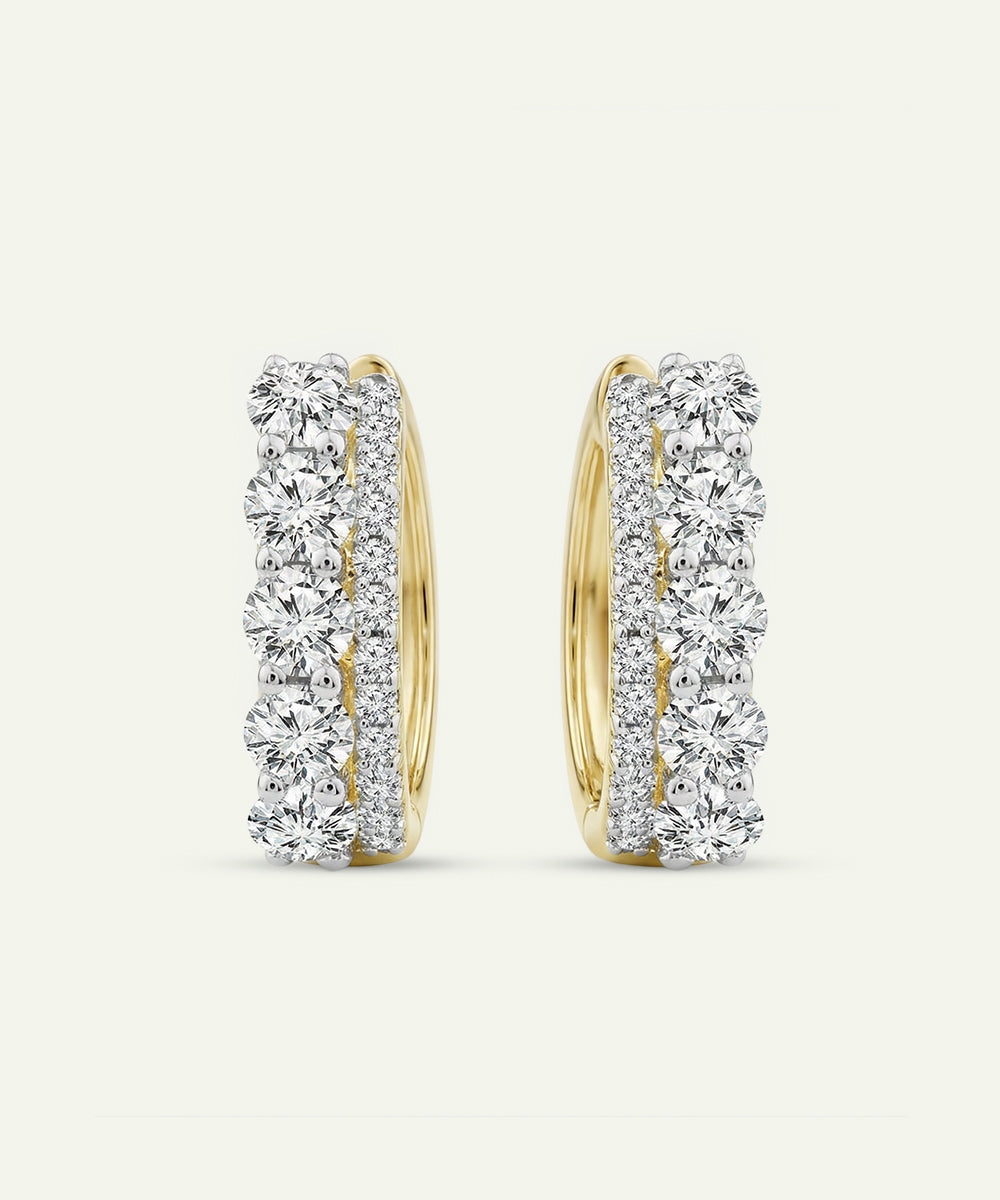 Pair of diamond hoop earrings on a light gray background