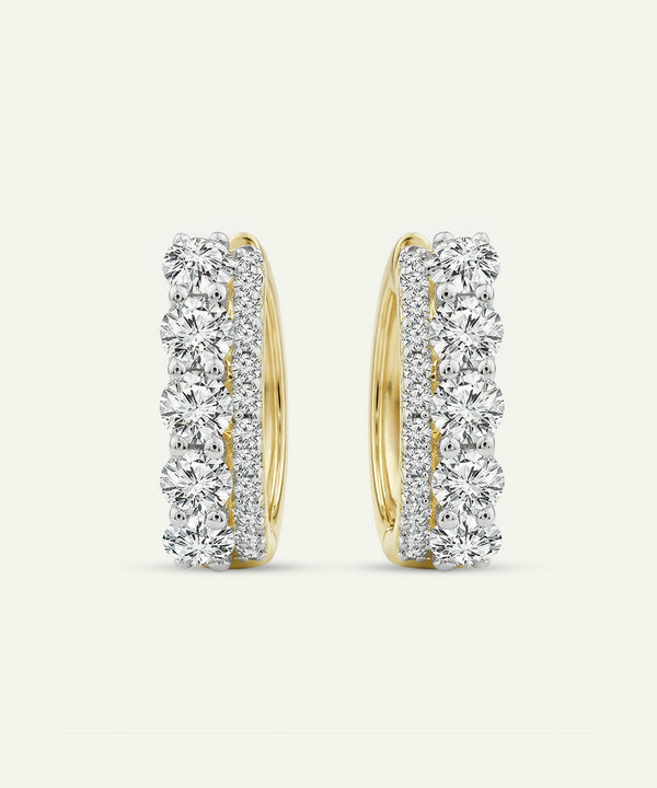 Pair of diamond hoop earrings on a light gray background