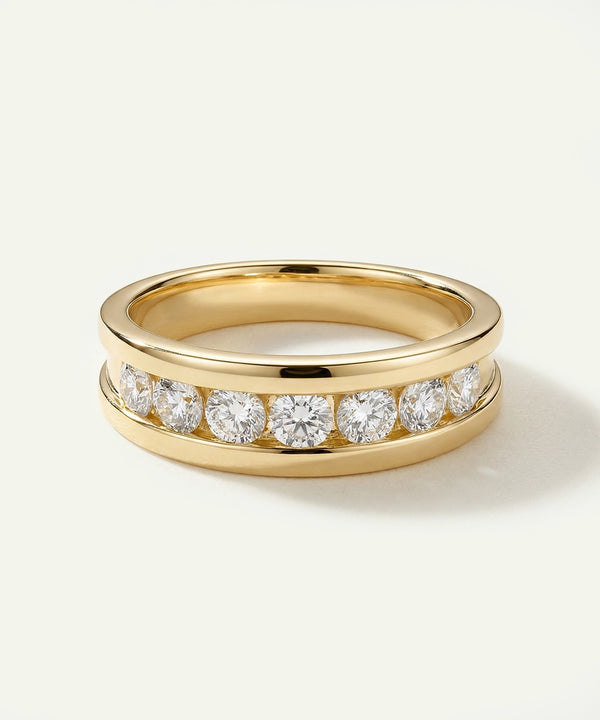 Gold ring with diamonds on a light beige background