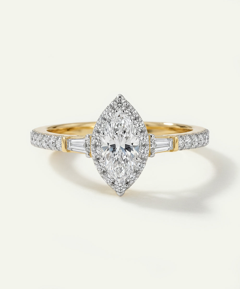 Gold and diamond ring on a light gray background