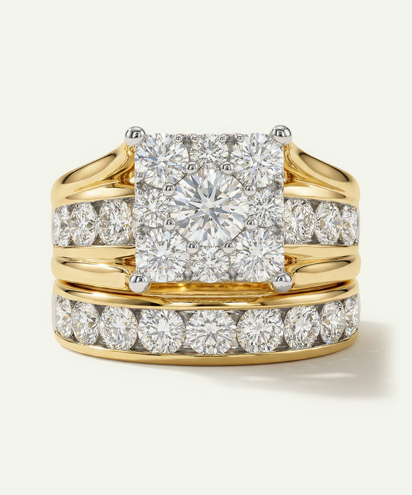 Gold ring with a large diamond and smaller diamonds on the band against a white background