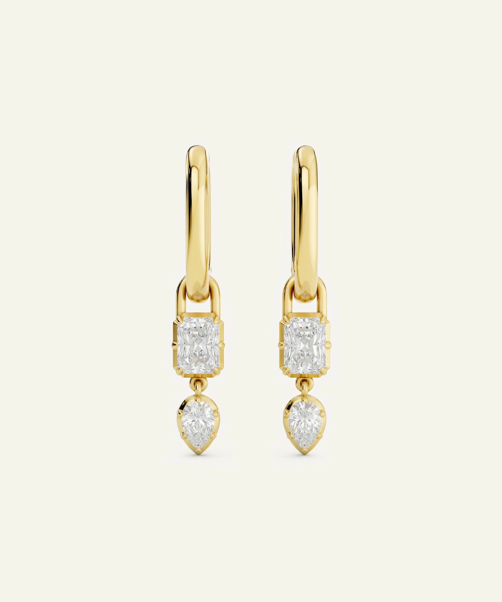 Gold earrings with diamond-like stones on a white background