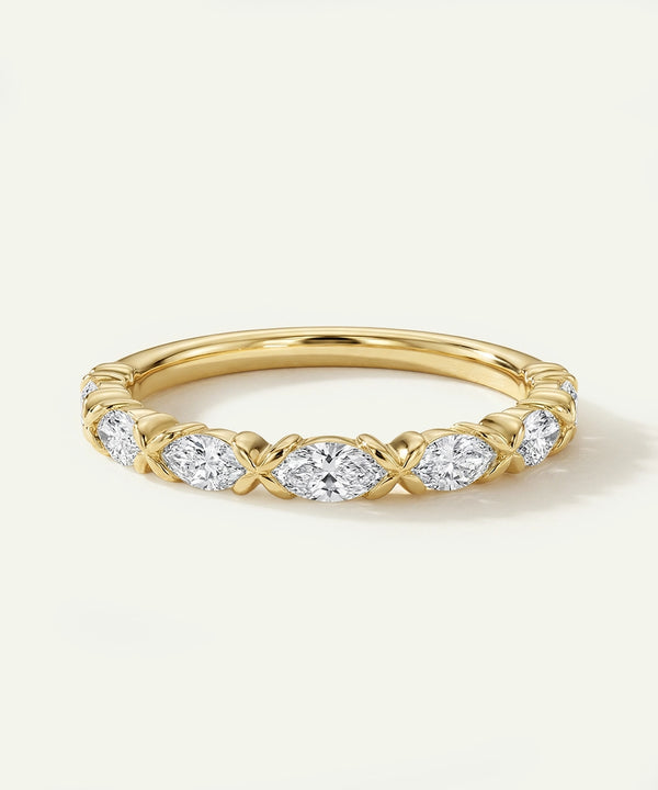 Gold ring with diamond accents on a light background