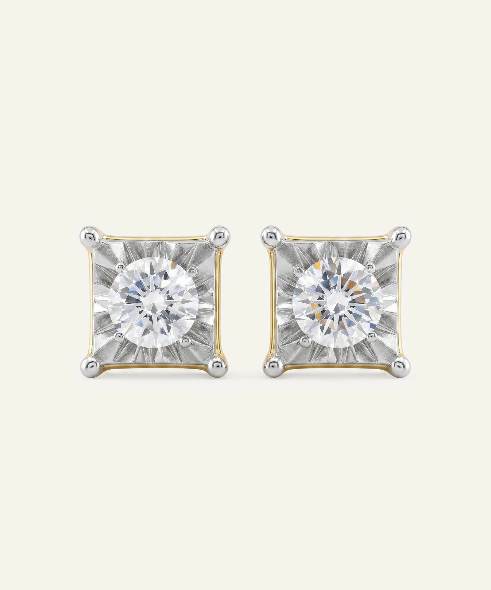 Pair of diamond stud earrings on a light gray background