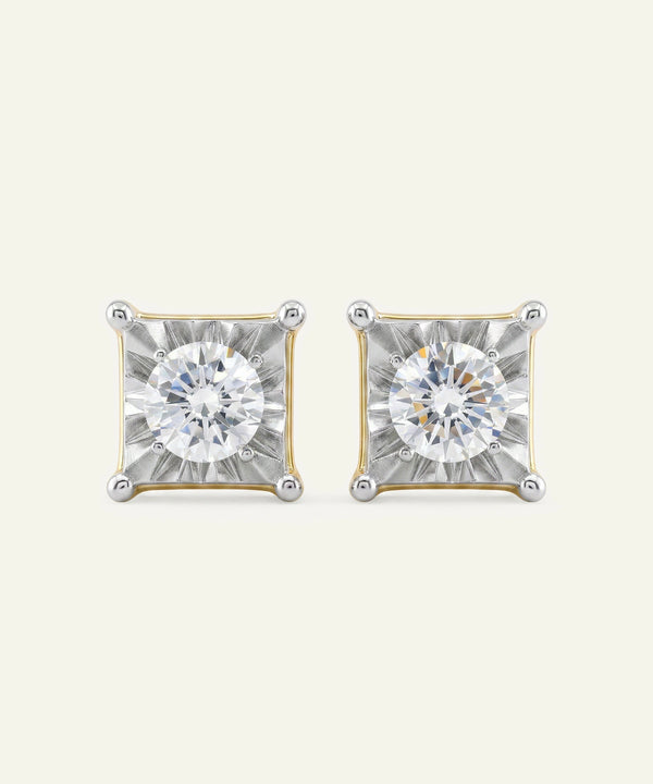 Pair of diamond stud earrings on a light gray background