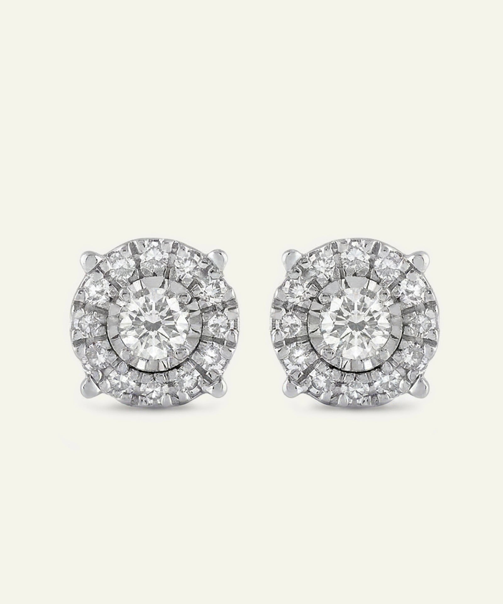 Pair of diamond stud earrings on a light gray background