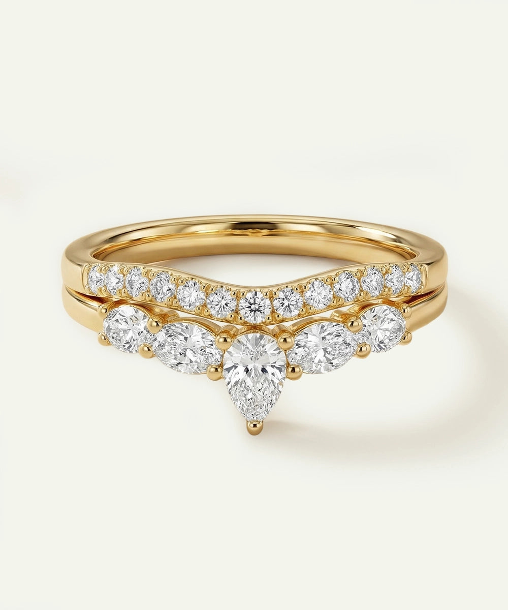 Gold ring with diamond accents on a light background