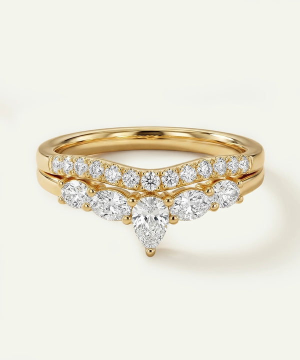 Gold ring with diamond accents on a light background