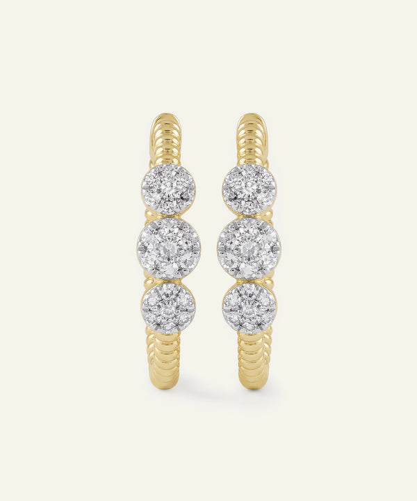 Gold hoop earrings with diamond beads on a white background