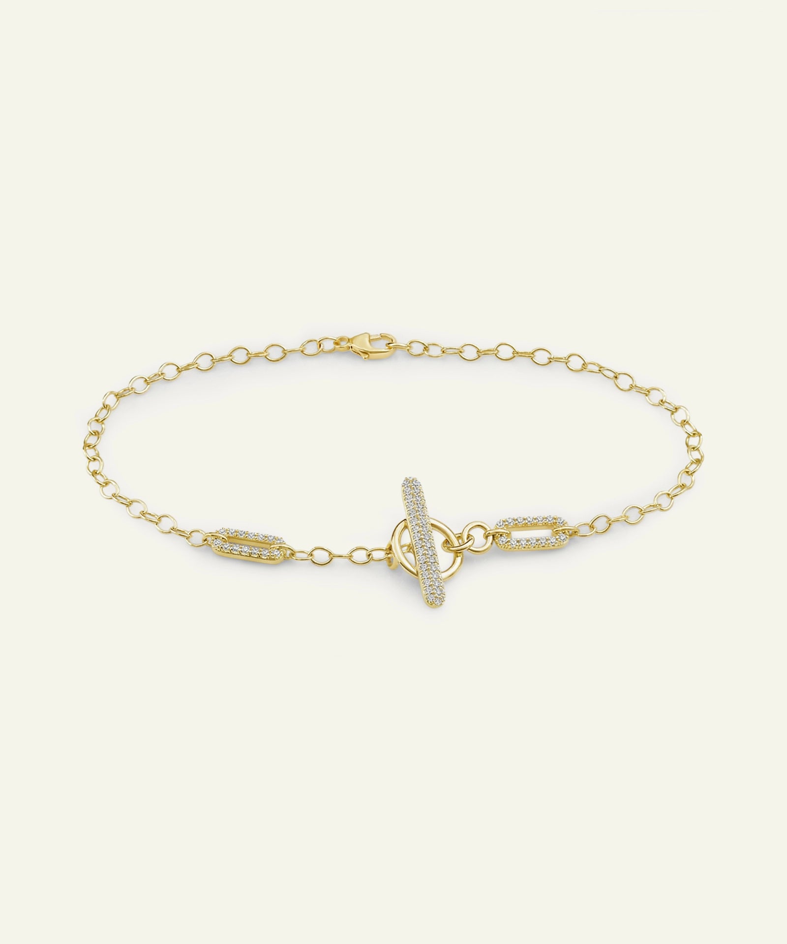 Gold bracelet with a unique clasp design on a white background