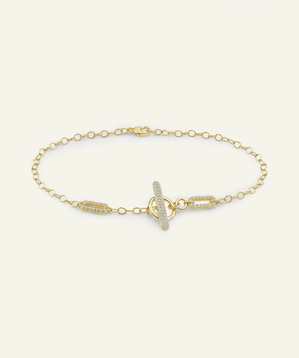 Gold bracelet with a unique clasp design on a white background
