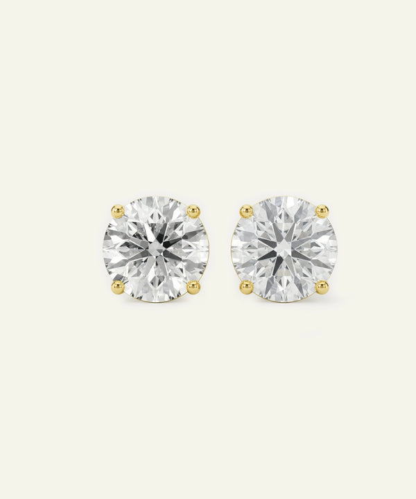 Pair of diamond stud earrings on a white background
