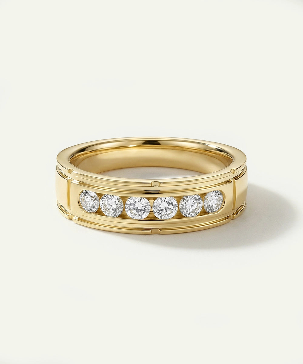 Gold ring with embedded diamonds on a light beige background