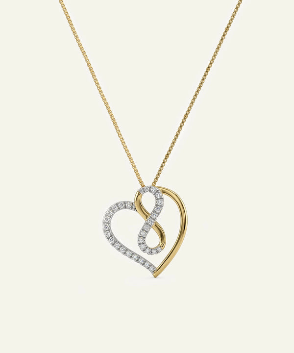 Gold and silver heart-shaped pendant on a chain against a beige background