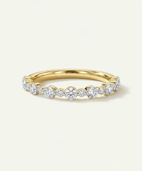 Gold ring with diamonds on a light beige background