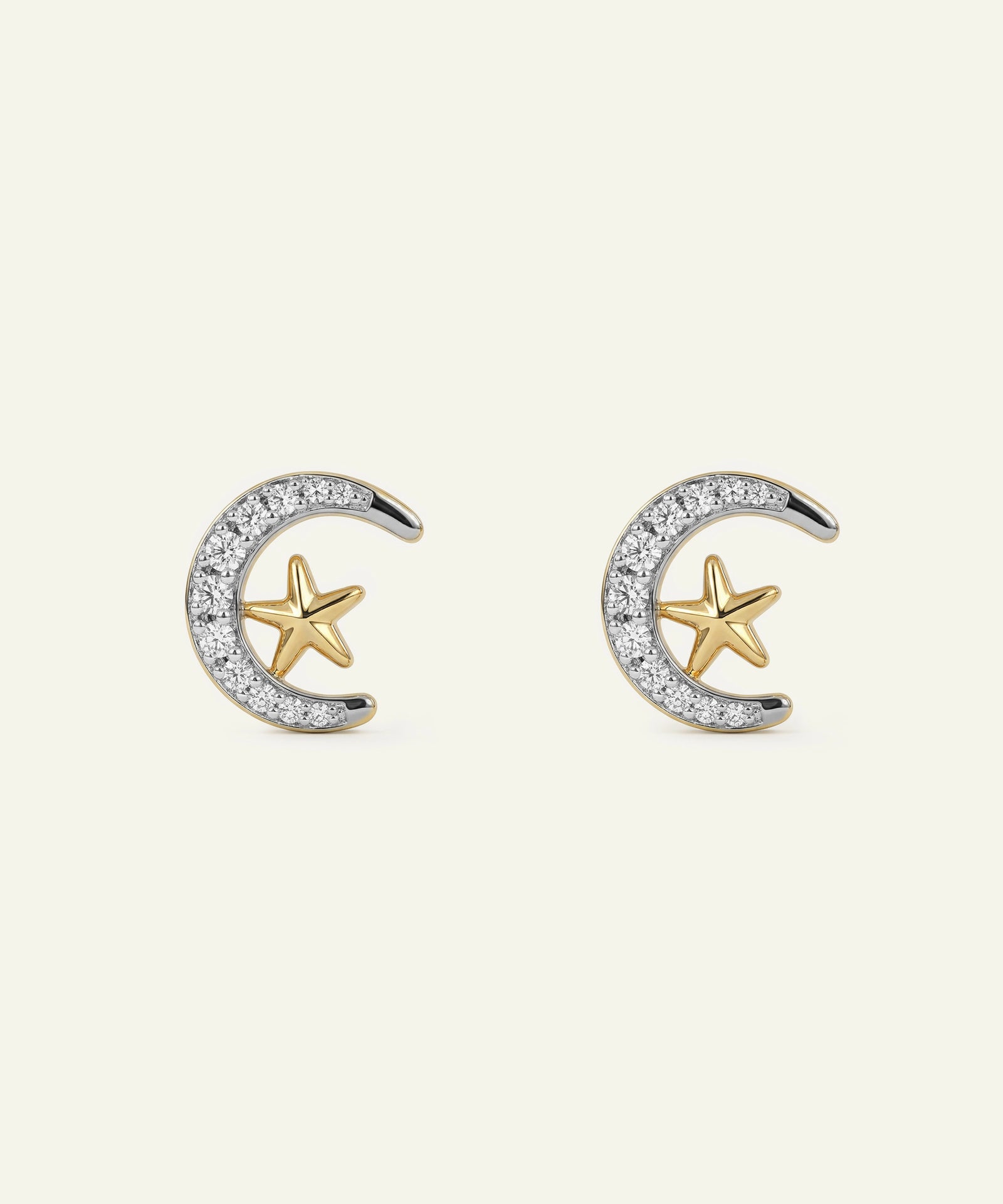 Pair of gold and silver earrings with star and crescent designs on a white background