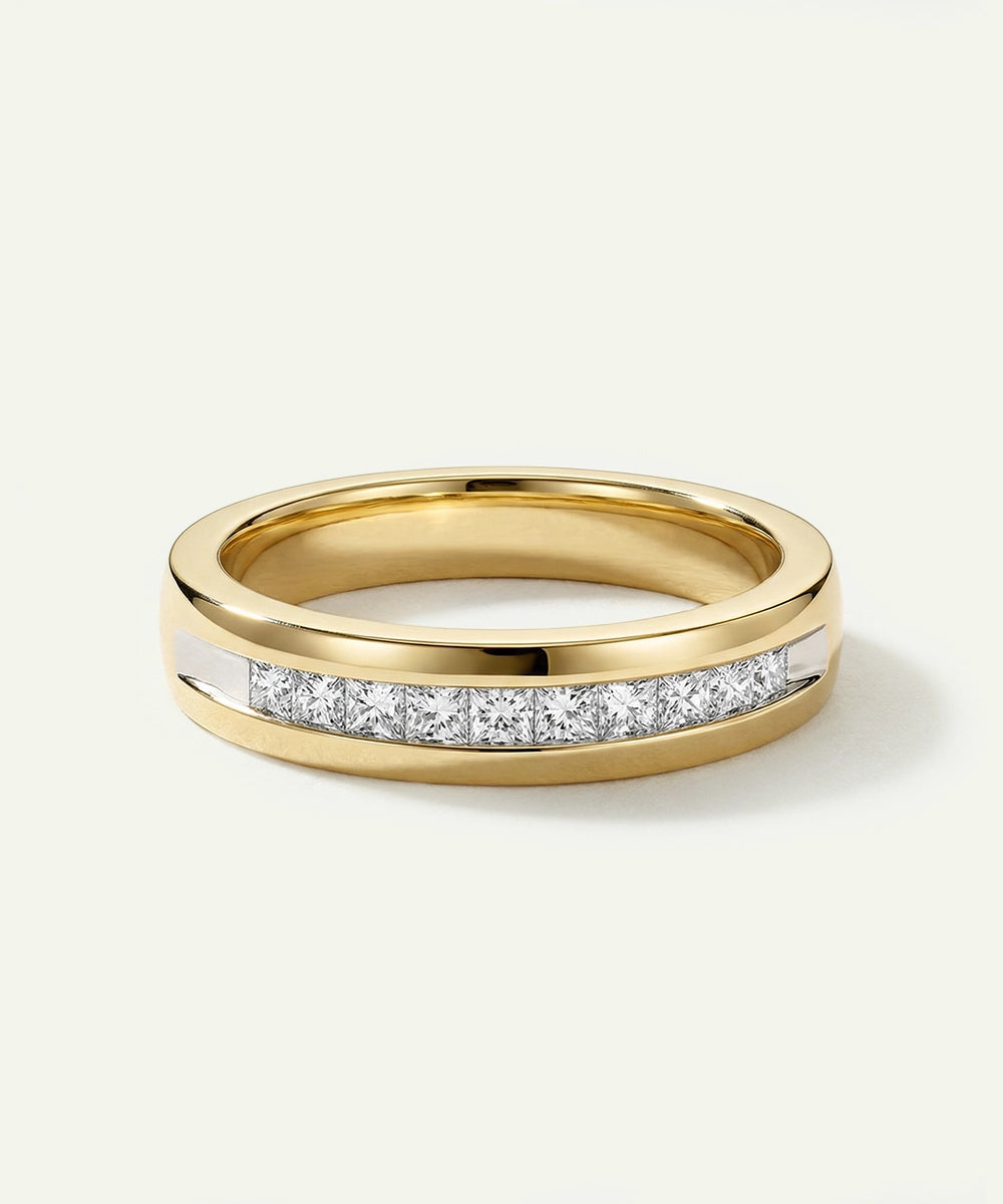 Gold ring with embedded diamonds on a white background