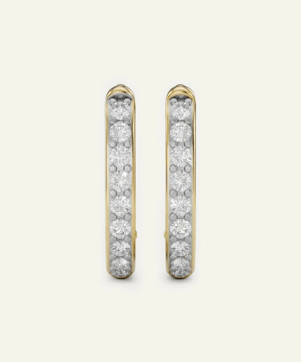 Gold hoop earrings with embedded diamonds on a light gray background