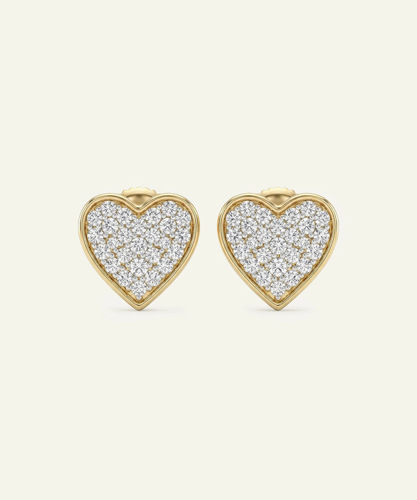 Heart-shaped earrings with diamond pavé on a white background