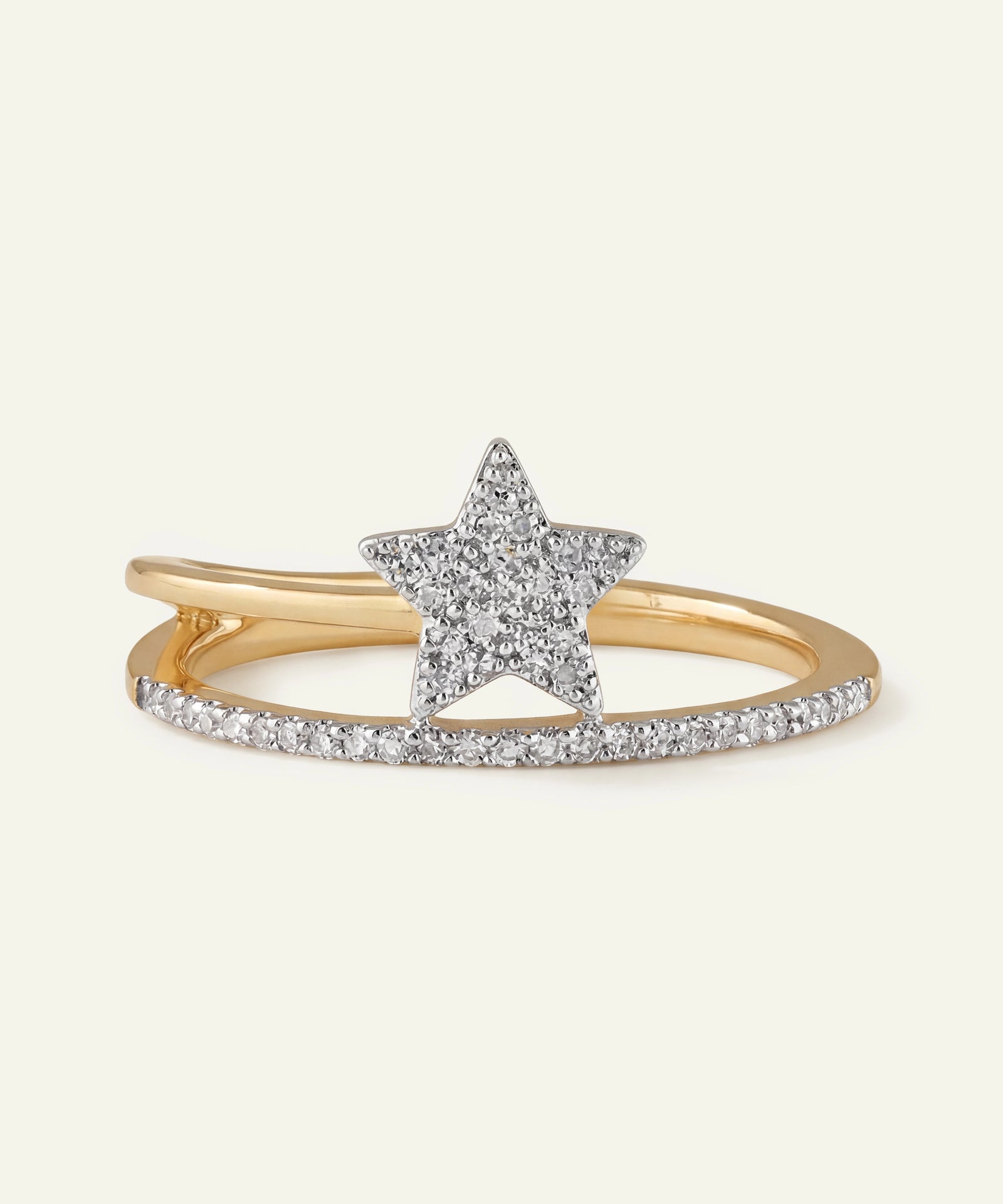 Gold ring with a star-shaped center and diamond accents on a white background