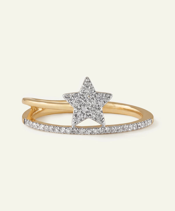 Gold ring with a star-shaped center and diamond accents on a white background