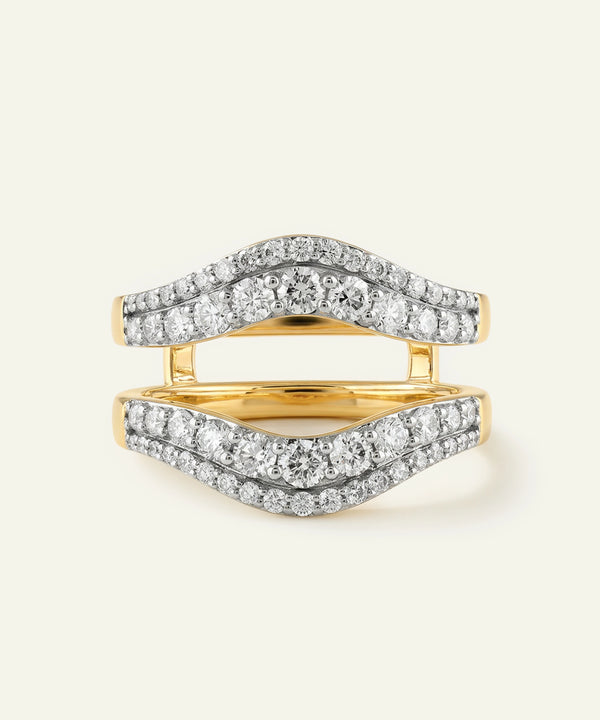 Gold and silver ring with diamond accents on a white background