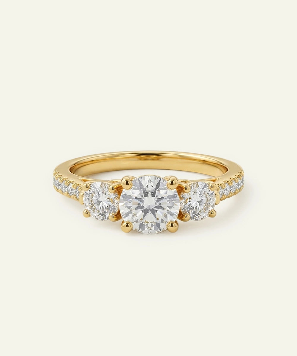 Gold ring with three diamonds on a white background