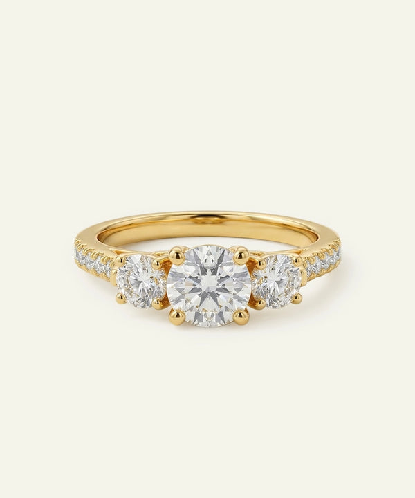 Gold ring with three diamonds on a white background