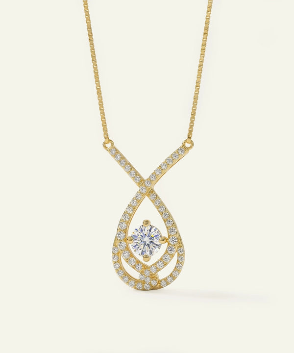 Gold necklace with a diamond pendant on a light beige background