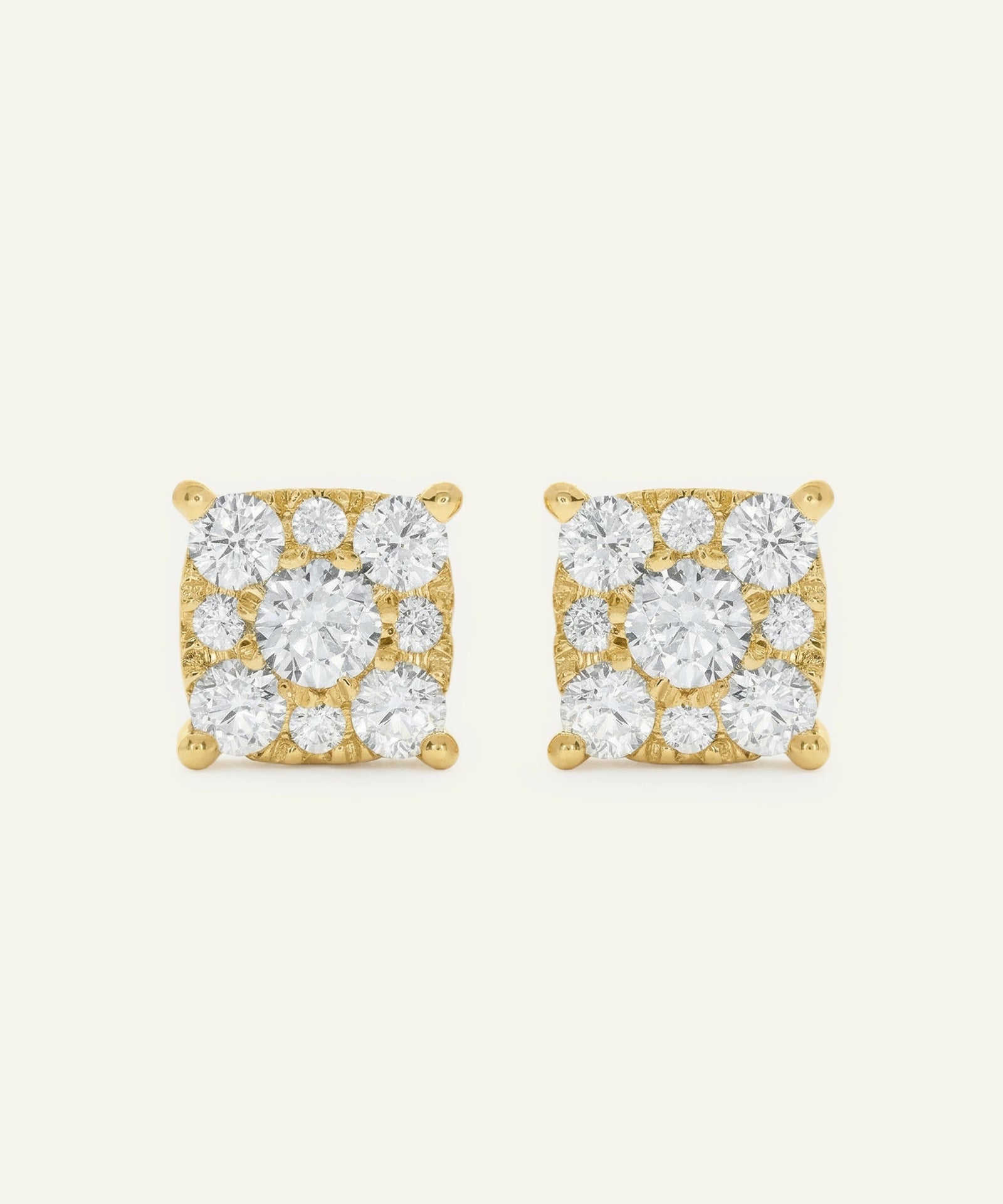 Pair of gold square-shaped earrings with clear gemstones on a white background