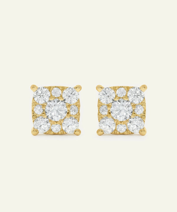 Pair of gold square-shaped earrings with clear gemstones on a white background