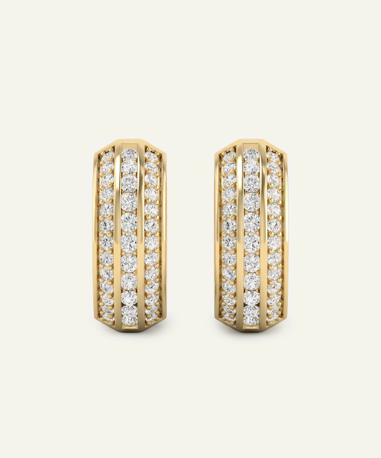 Gold hoop earrings with diamond accents on a light beige background