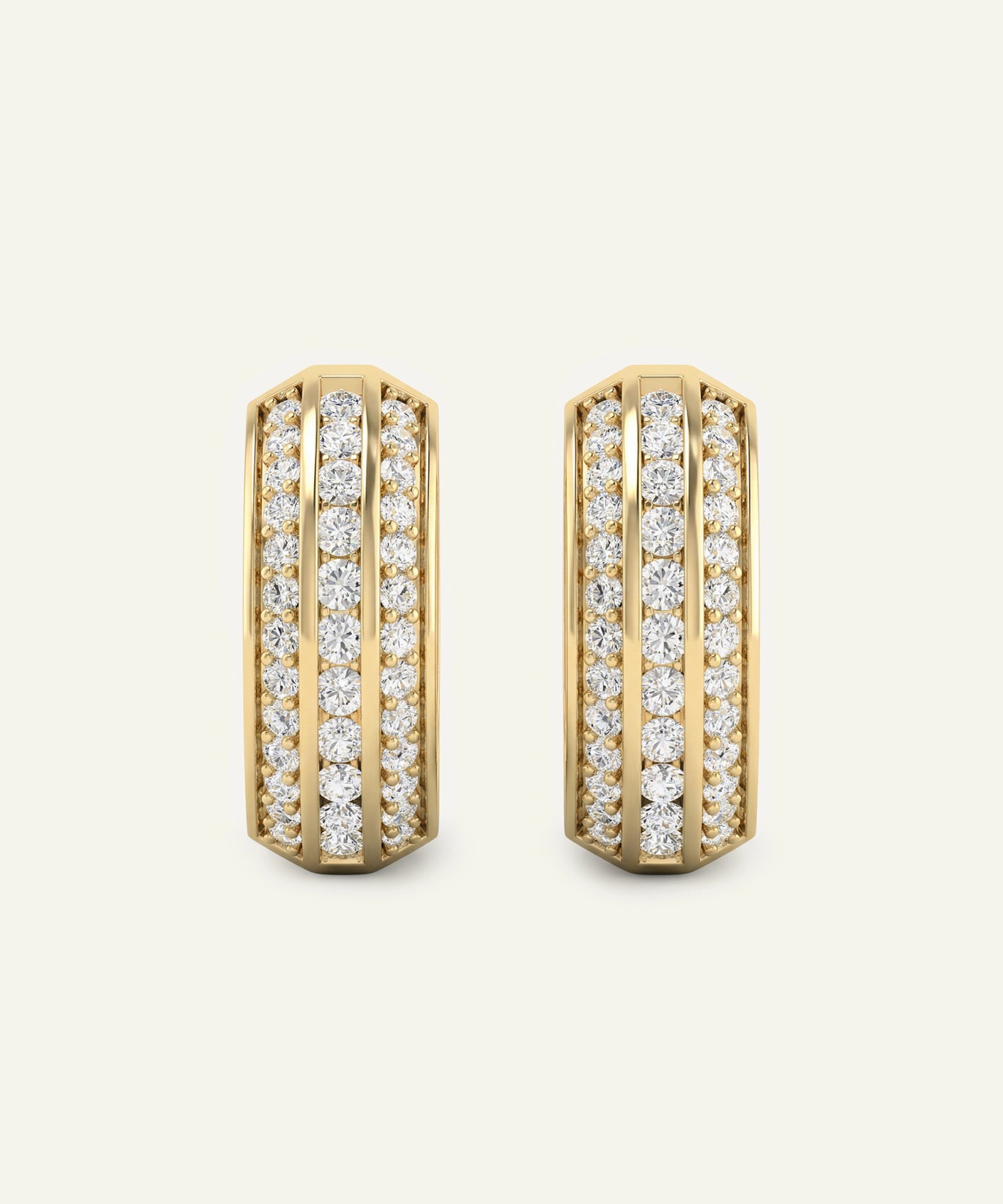 Gold hoop earrings with diamond accents on a light beige background