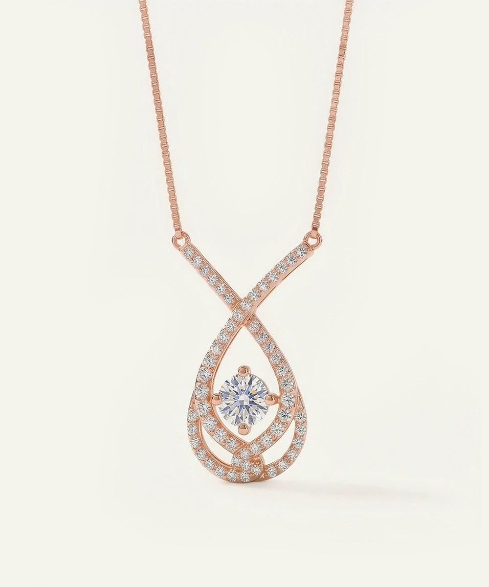 Rose gold necklace with a diamond pendant on a light beige background