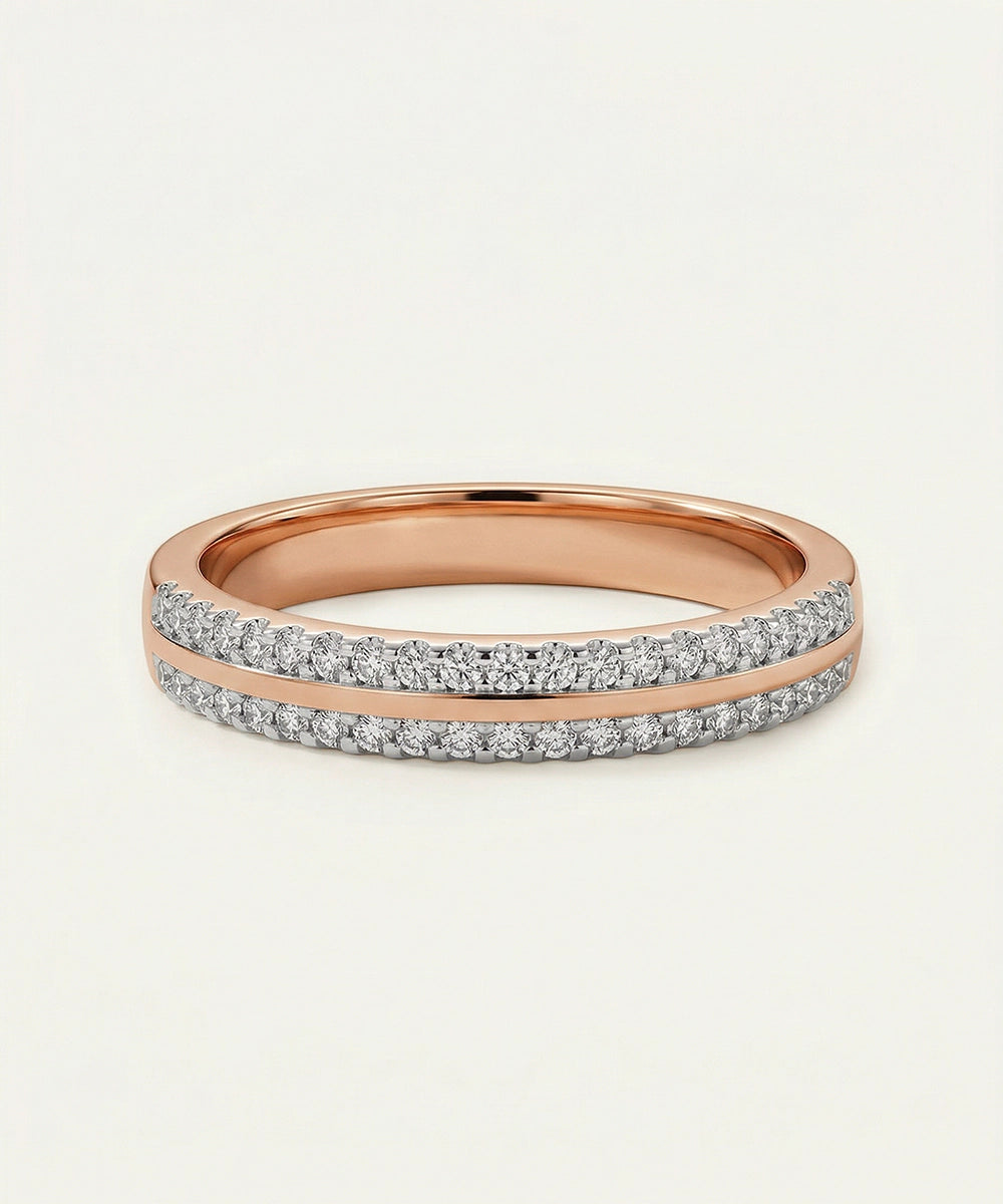 Rose gold ring with diamond accents on a light beige background