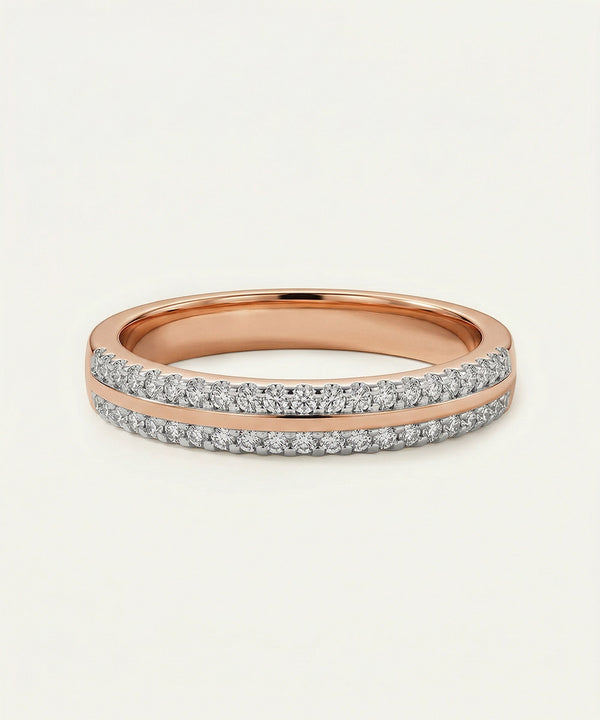 Rose gold ring with diamond accents on a light beige background