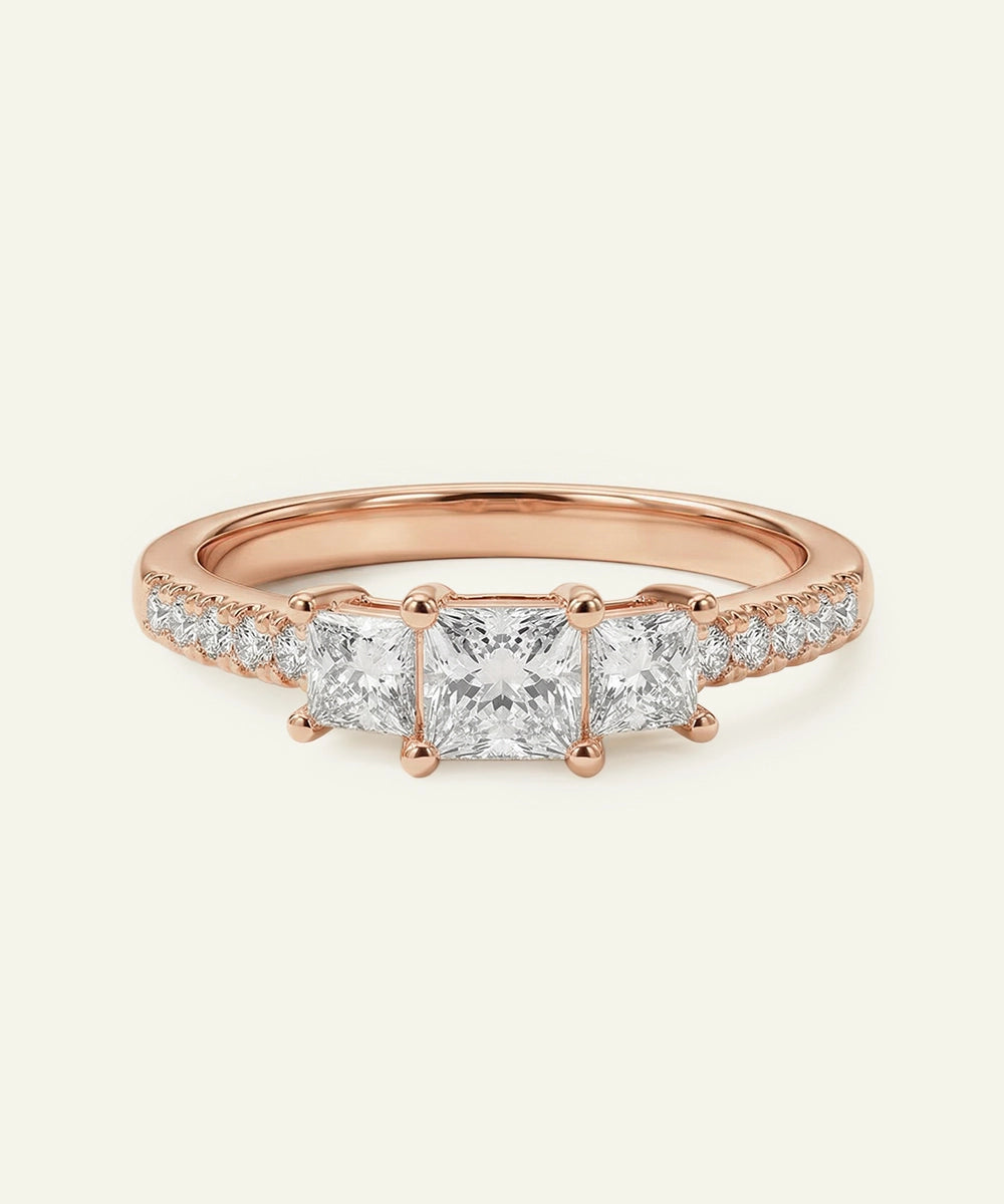 Rose gold ring with diamond stones on a light beige background